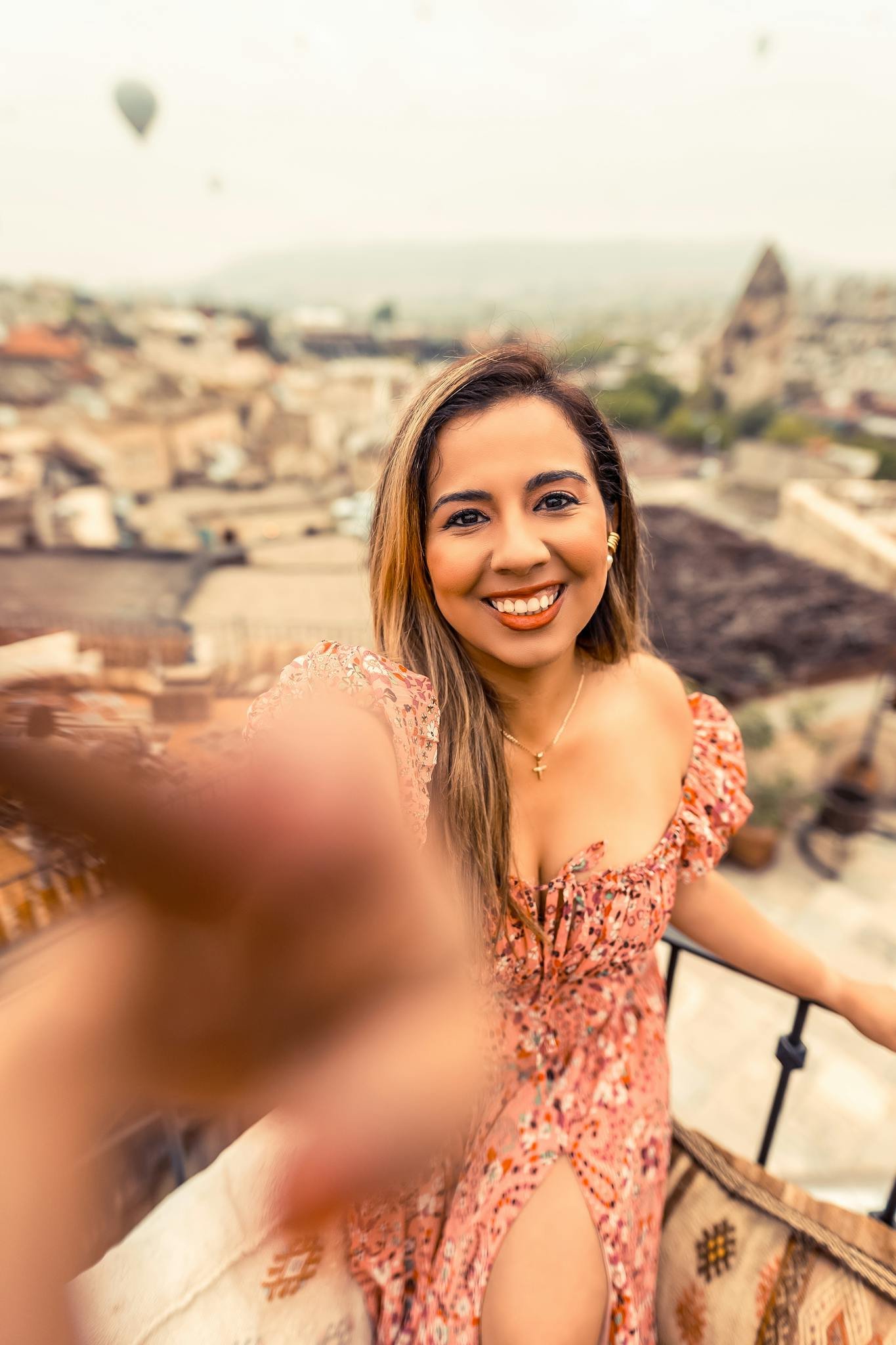 smiling woman in floral dress with cappadocia